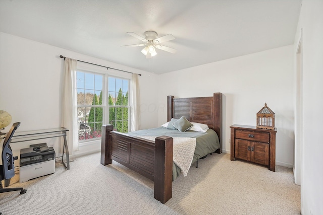 bedroom with baseboards, ceiling fan, and light colored carpet