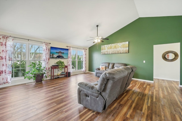 living area featuring ceiling fan, vaulted ceiling, baseboards, and wood finished floors