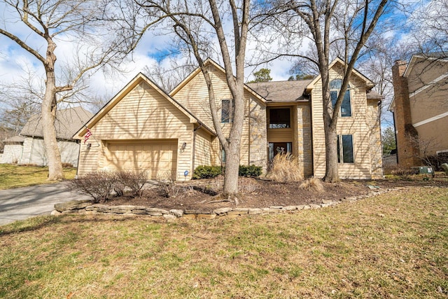 traditional home featuring a garage, driveway, and a front lawn