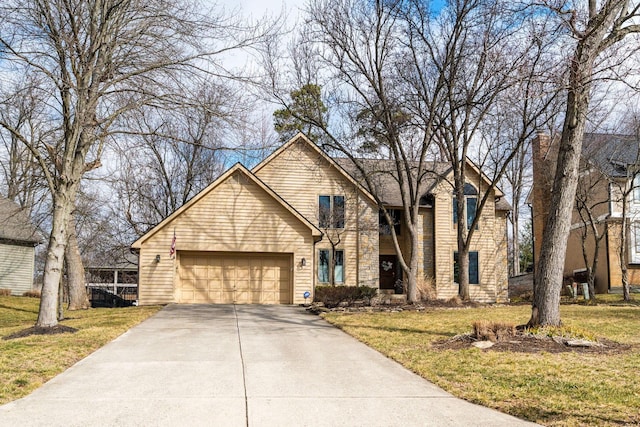 traditional-style home featuring a garage, driveway, and a front lawn