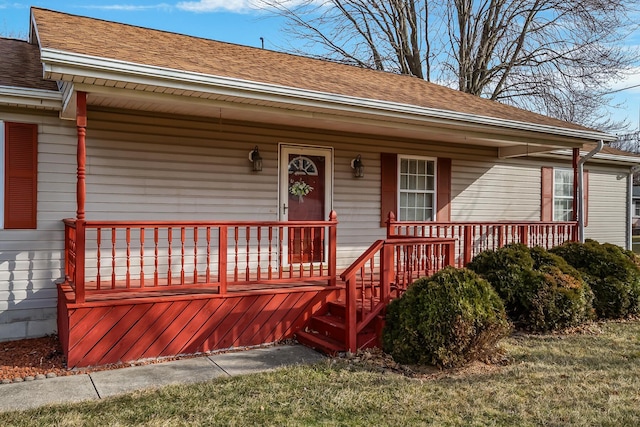 view of front of property with a shingled roof and a porch