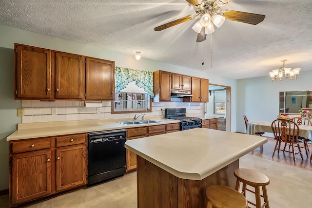 kitchen with a wealth of natural light, brown cabinets, a sink, and black appliances