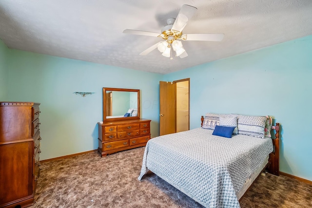 carpeted bedroom featuring ceiling fan, baseboards, and a textured ceiling