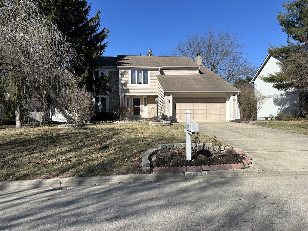 view of front of home with an attached garage, a chimney, and driveway