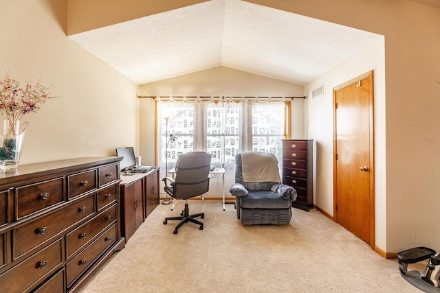 office area with a textured ceiling, visible vents, baseboards, light carpet, and vaulted ceiling