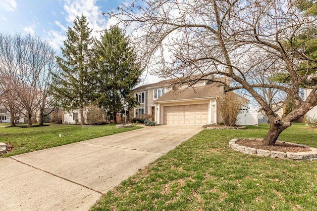 traditional-style house with a garage, a front lawn, and concrete driveway
