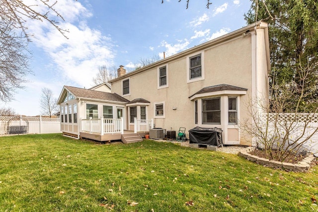 back of house with cooling unit, stucco siding, fence, a deck, and a lawn