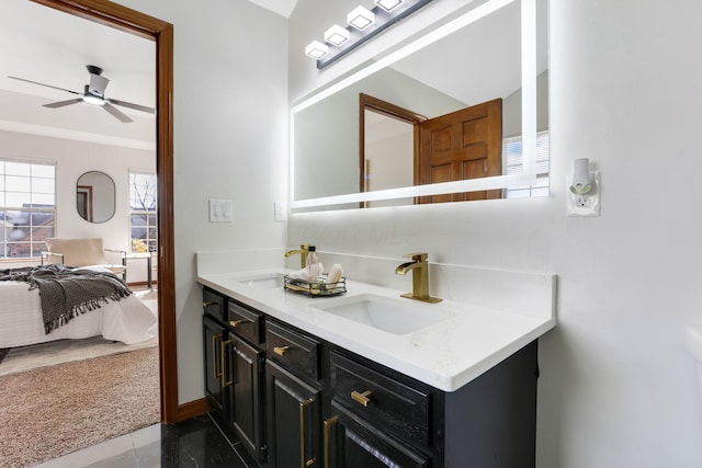 bathroom featuring double vanity, ensuite bath, ceiling fan, and a sink