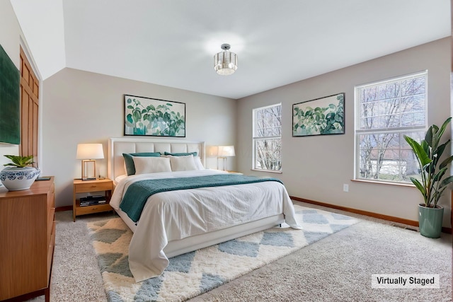 bedroom featuring carpet flooring, multiple windows, lofted ceiling, and baseboards