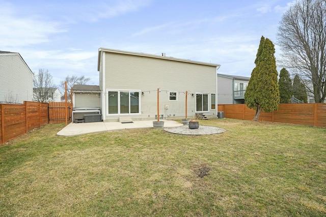 back of house with a yard, a patio area, and a fenced backyard