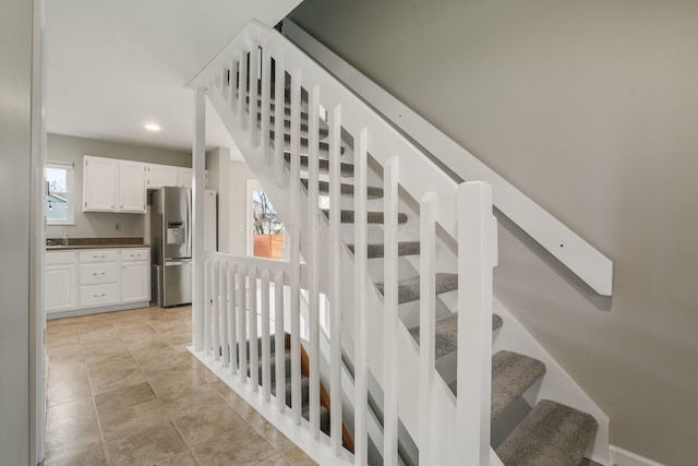 staircase featuring tile patterned floors and recessed lighting