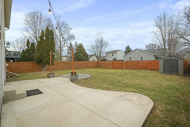 view of yard featuring a patio, an outdoor structure, a fenced backyard, and a shed