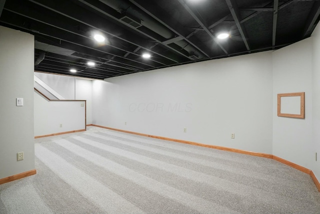 finished basement featuring carpet flooring, visible vents, and baseboards