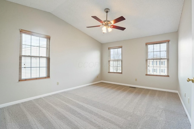 spare room with ceiling fan, baseboards, carpet, and lofted ceiling