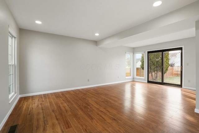 spare room with visible vents, recessed lighting, baseboards, and hardwood / wood-style floors