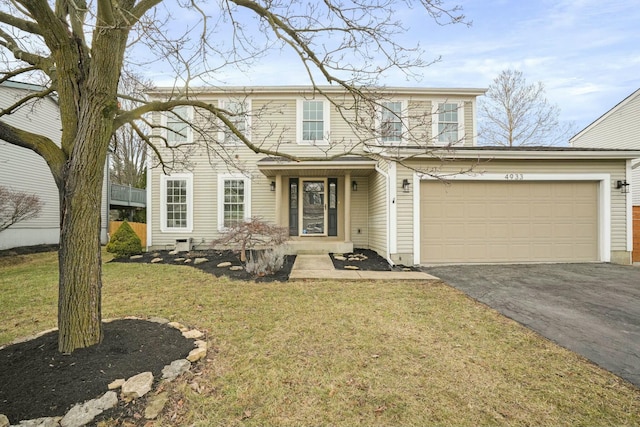 view of front of house featuring aphalt driveway, an attached garage, and a front yard