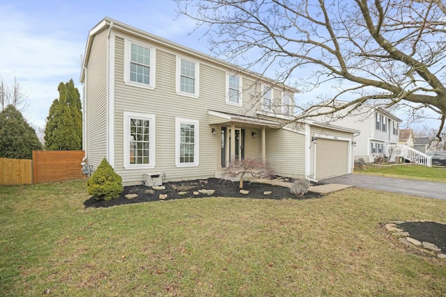 view of front of property with driveway, an attached garage, a front yard, and fence