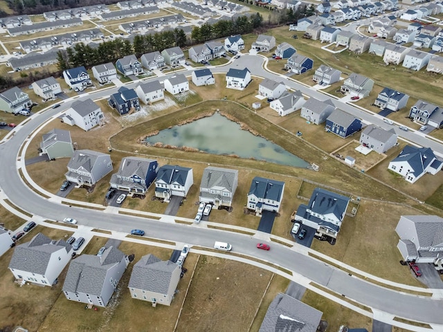 drone / aerial view featuring a residential view and a water view