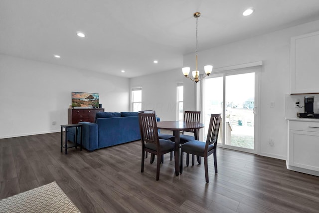 dining space with dark wood-type flooring, recessed lighting, baseboards, and a chandelier