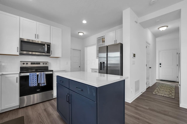 kitchen with light countertops, white cabinets, visible vents, and appliances with stainless steel finishes