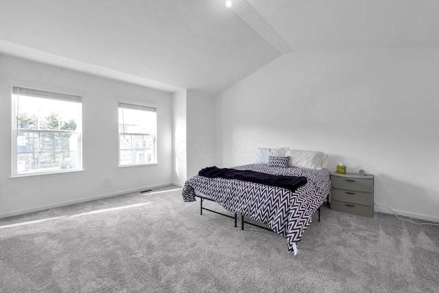 bedroom featuring visible vents, baseboards, lofted ceiling, and carpet