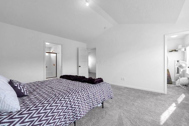 bedroom with baseboards, lofted ceiling, ensuite bath, and carpet flooring