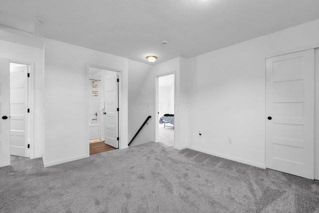 carpeted empty room with baseboards