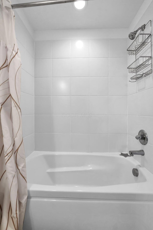 bathroom featuring shower / bathtub combination with curtain