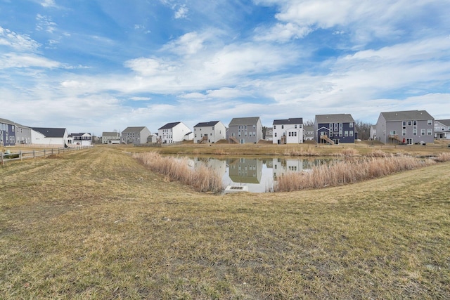 surrounding community featuring a residential view, a lawn, and fence