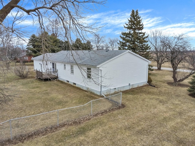 view of property exterior with fence, a deck, a lawn, and roof with shingles