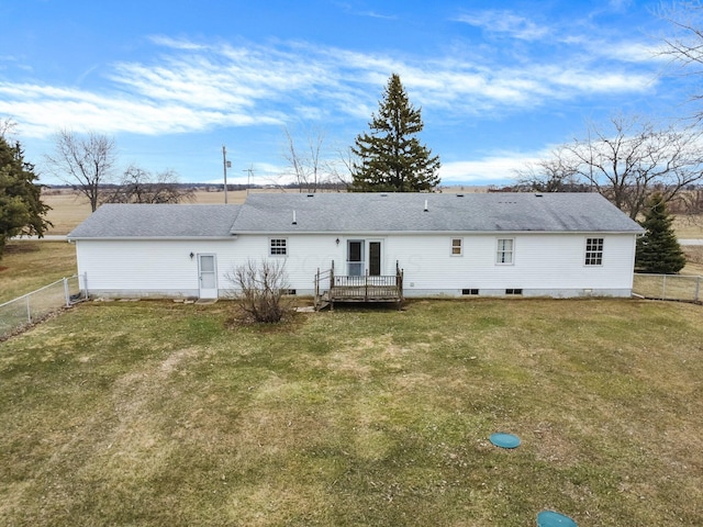 back of house with fence, a lawn, and roof with shingles