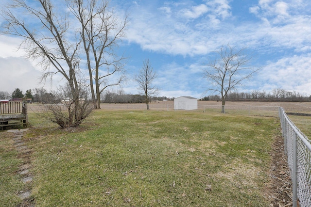 view of yard with a rural view and fence