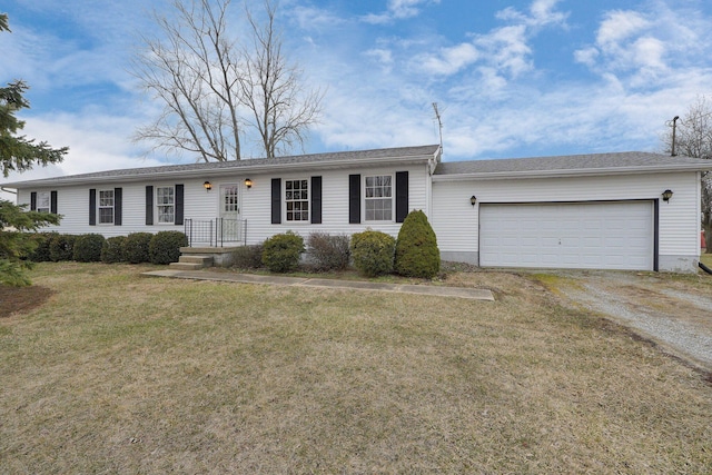 ranch-style home with driveway, a garage, and a front yard