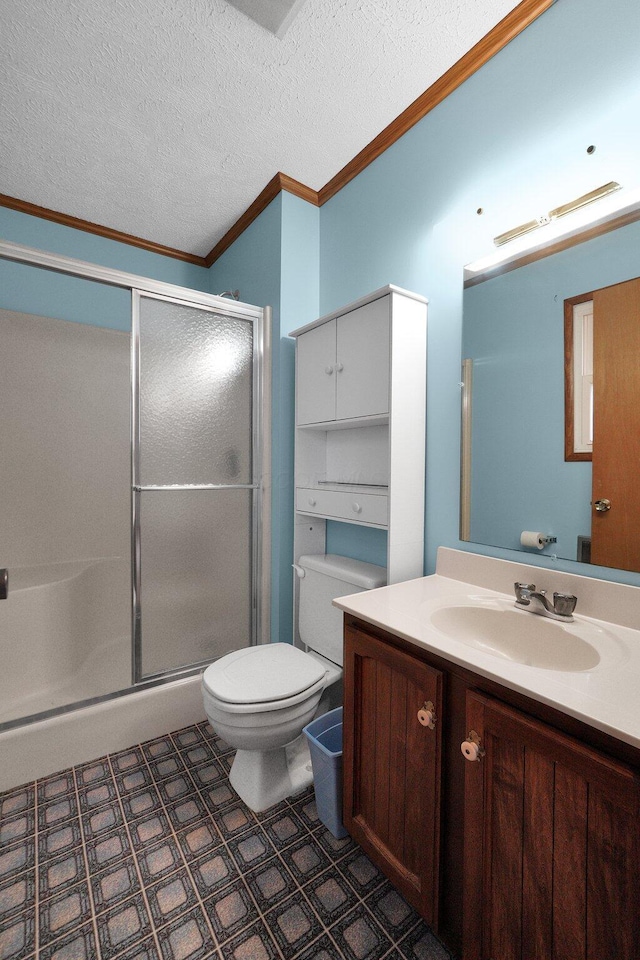 bathroom with ornamental molding, a shower stall, toilet, and a textured ceiling