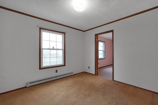 carpeted empty room featuring a baseboard heating unit, a textured ceiling, and crown molding