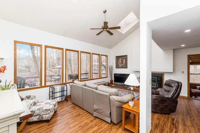 living room featuring a wealth of natural light, lofted ceiling, and wood finished floors