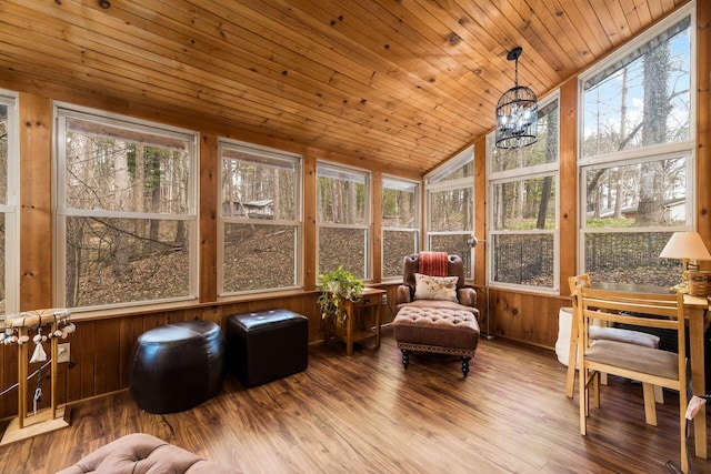 sunroom / solarium featuring lofted ceiling, wood ceiling, and a chandelier