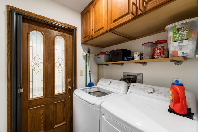 washroom featuring cabinet space and washing machine and dryer