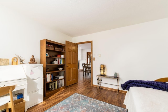 bedroom featuring baseboards and wood finished floors