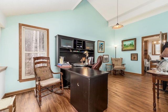 office area featuring baseboards, lofted ceiling, and wood finished floors