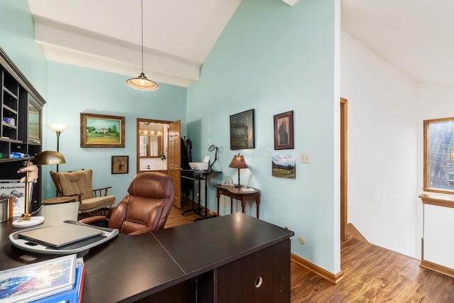 office featuring high vaulted ceiling, baseboards, and wood finished floors