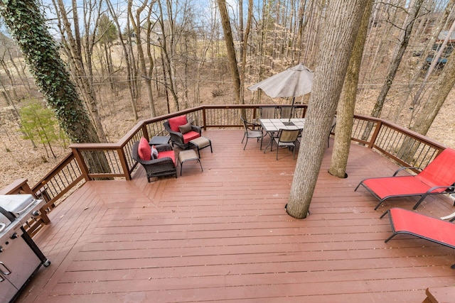 wooden deck featuring outdoor dining area