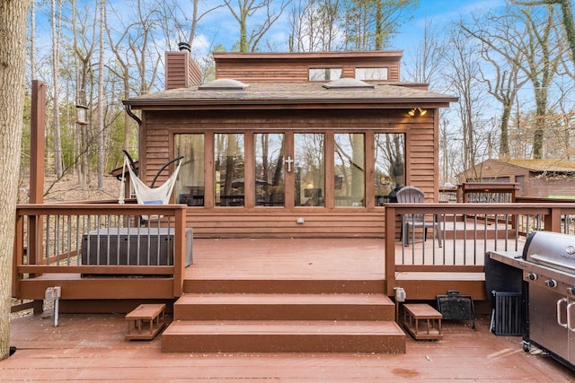 wooden terrace featuring cooling unit and a grill