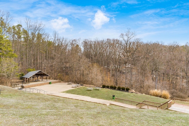 view of yard featuring a gazebo and a forest view