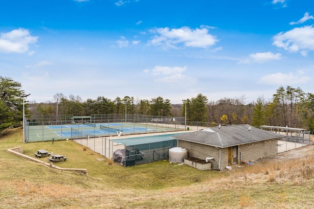 view of swimming pool with a lawn, a tennis court, and fence