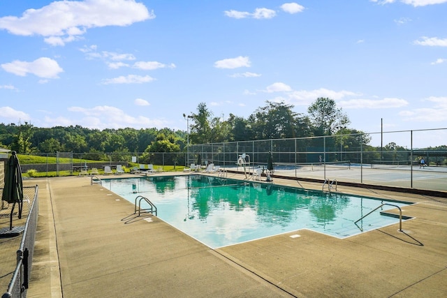 pool featuring a patio area and fence