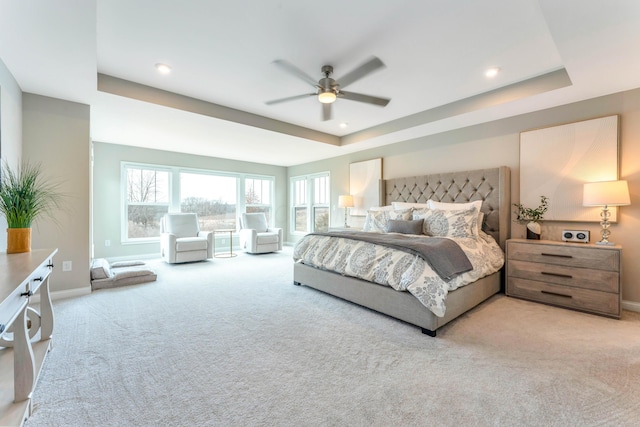 bedroom featuring a ceiling fan, a tray ceiling, recessed lighting, carpet floors, and baseboards