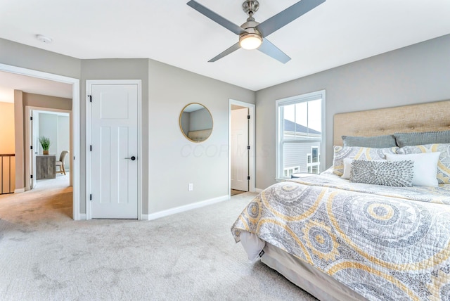 carpeted bedroom with baseboards and a ceiling fan