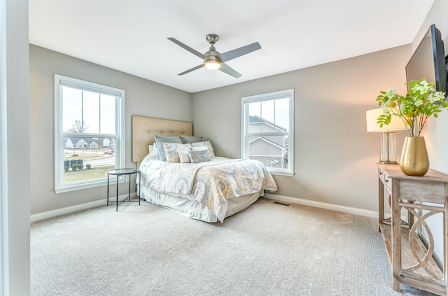 bedroom with visible vents, baseboards, a ceiling fan, and carpet flooring