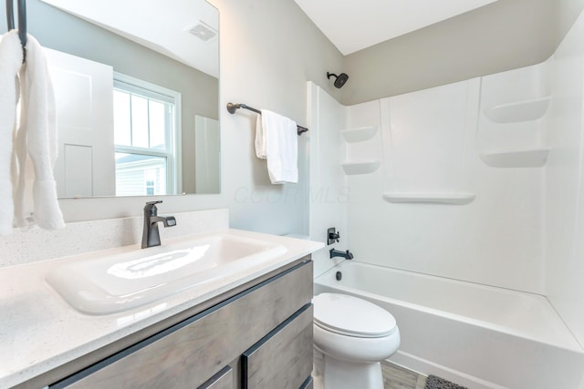 full bathroom featuring vanity, wood finished floors, visible vents, toilet, and shower / bathtub combination